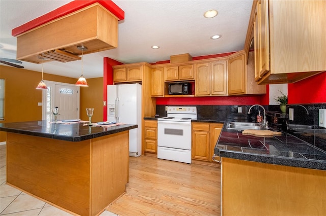kitchen featuring light wood-type flooring, tile counters, white appliances, a kitchen island, and a sink