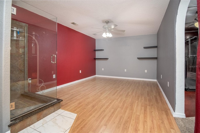 unfurnished room featuring visible vents, ceiling fan, wood finished floors, and baseboards