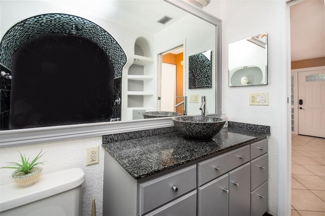 bathroom featuring tile patterned flooring, vanity, visible vents, and toilet