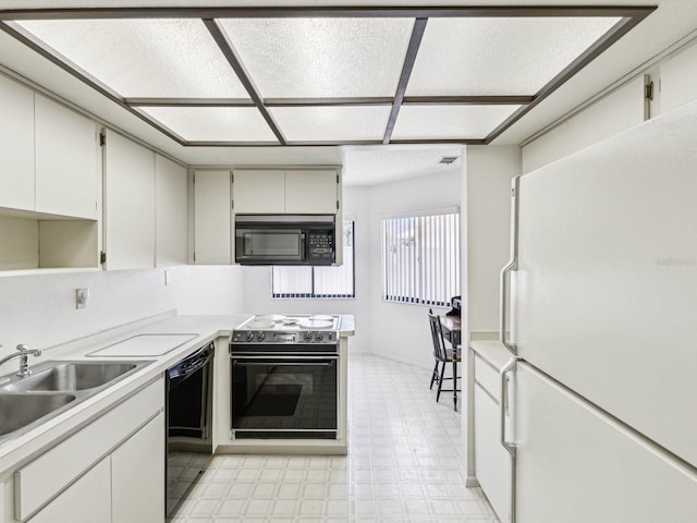 456 Lakeview Dr Unit 5, Palm Harbor, FL 34683 - kitchen featuring black appliances, light flooring, a sink, and light countertops