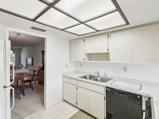 456 Lakeview Dr Unit 5, Palm Harbor, FL 34683 - kitchen with black dishwasher, a sink, light countertops, freestanding refrigerator, and light floors