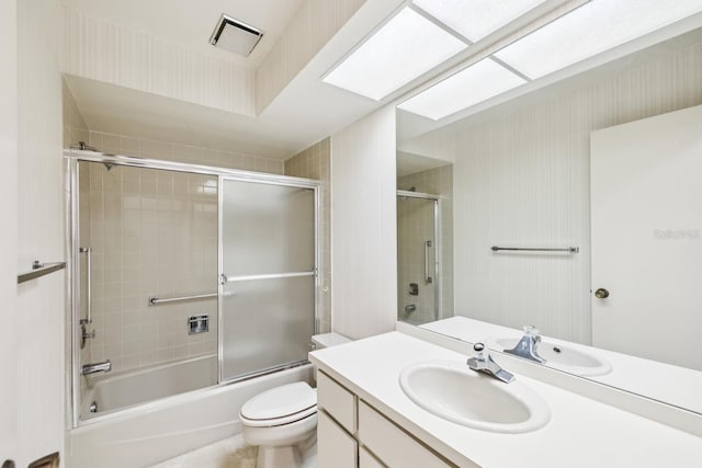 456 Lakeview Dr Unit 5, Palm Harbor, FL 34683 - bathroom with toilet, vanity, and shower / bath combination with glass door