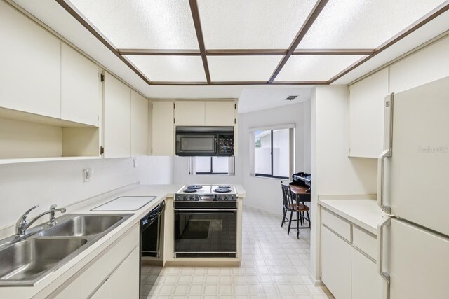 456 Lakeview Dr Unit 5, Palm Harbor, FL 34683 - kitchen featuring black appliances, a sink, light floors, light countertops, and open shelves