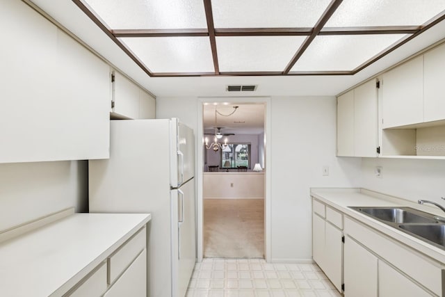 456 Lakeview Dr Unit 5, Palm Harbor, FL 34683 - kitchen featuring freestanding refrigerator, a sink, light countertops, and light carpet