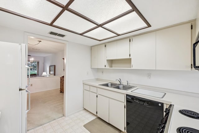 456 Lakeview Dr Unit 5, Palm Harbor, FL 34683 - kitchen with freestanding refrigerator, black dishwasher, a sink, light countertops, and light floors