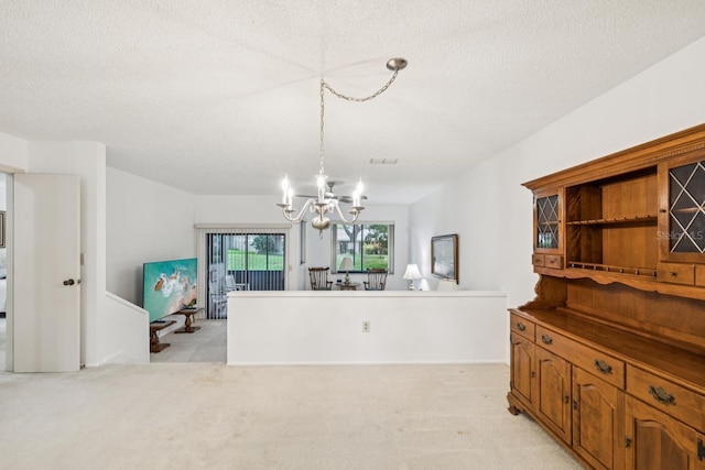 456 Lakeview Dr Unit 5, Palm Harbor, FL 34683 - dining room with a chandelier, a textured ceiling, and light carpet