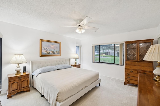 456 Lakeview Dr Unit 5, Palm Harbor, FL 34683 - bedroom featuring light carpet, ceiling fan, a textured ceiling, and baseboards