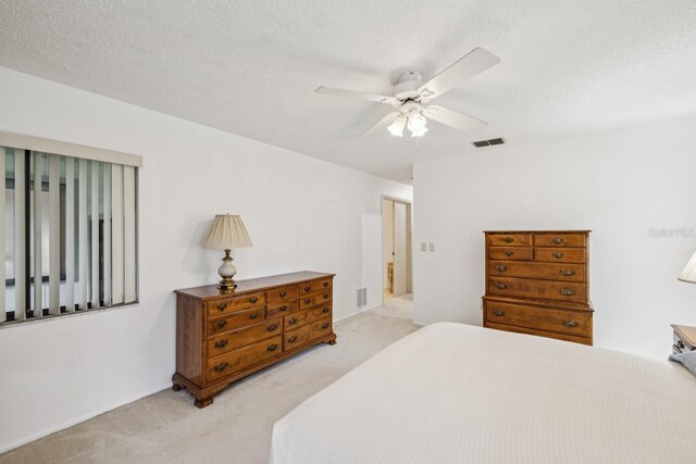 456 Lakeview Dr Unit 5, Palm Harbor, FL 34683 - bedroom with light colored carpet, ceiling fan, and a textured ceiling