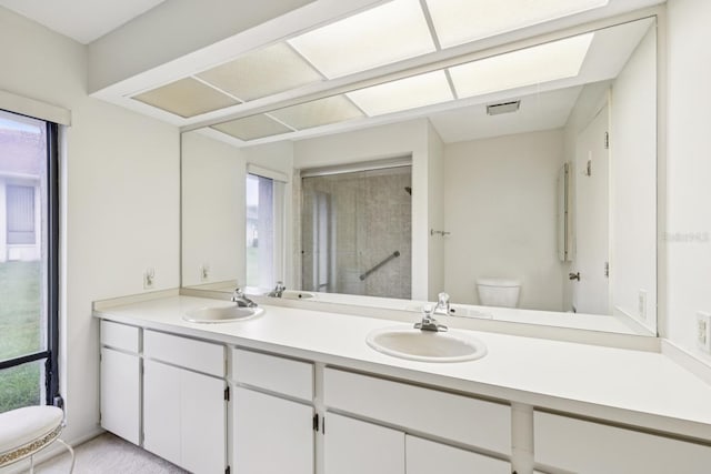 456 Lakeview Dr Unit 5, Palm Harbor, FL 34683 - bathroom featuring a stall shower, healthy amount of natural light, double vanity, and toilet