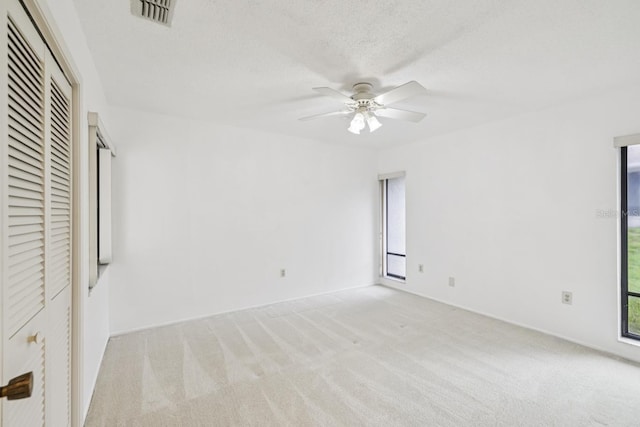 456 Lakeview Dr Unit 5, Palm Harbor, FL 34683 - unfurnished bedroom with carpet, a textured ceiling, ceiling fan, and baseboards