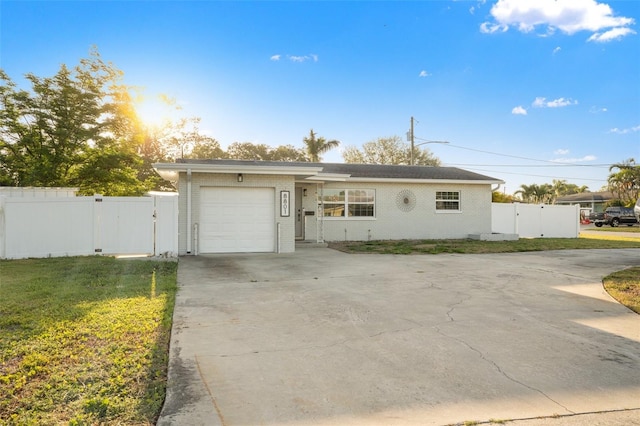 ranch-style home with a gate, driveway, a garage, and fence