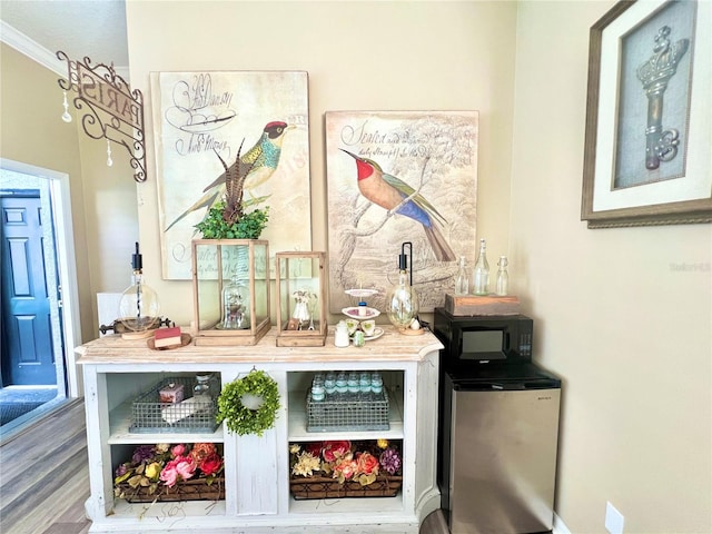 2332 Dekan Ln, Land O Lakes, FL 34639 - bar with wood finished floors, freestanding refrigerator, and crown molding