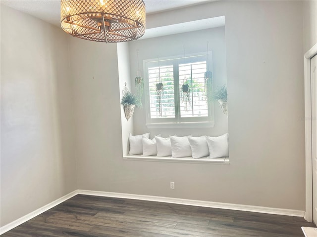 2332 Dekan Ln, Land O Lakes, FL 34639 - spare room with an inviting chandelier, dark wood-style flooring, and baseboards