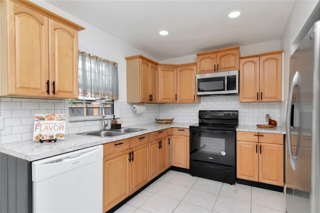 10705 Knollsway Ct, Tampa, FL 33625 - kitchen with light brown cabinetry, appliances with stainless steel finishes, light countertops, a sink, and decorative backsplash