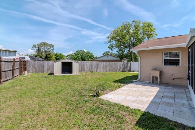 10705 Knollsway Ct, Tampa, FL 33625 - view of yard featuring a fenced backyard, an outdoor structure, a patio, and a storage unit