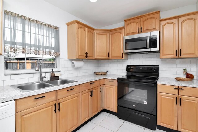 10705 Knollsway Ct, Tampa, FL 33625 - kitchen with white dishwasher, a sink, light countertops, stainless steel microwave, and black range with electric stovetop