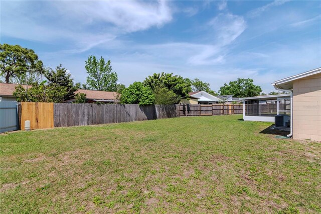 10705 Knollsway Ct, Tampa, FL 33625 - view of yard featuring cooling unit, a fenced backyard, and a sunroom
