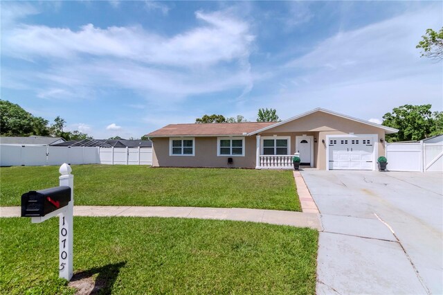 10705 Knollsway Ct, Tampa, FL 33625 - single story home featuring concrete driveway, stucco siding, a front yard, a garage, and fence