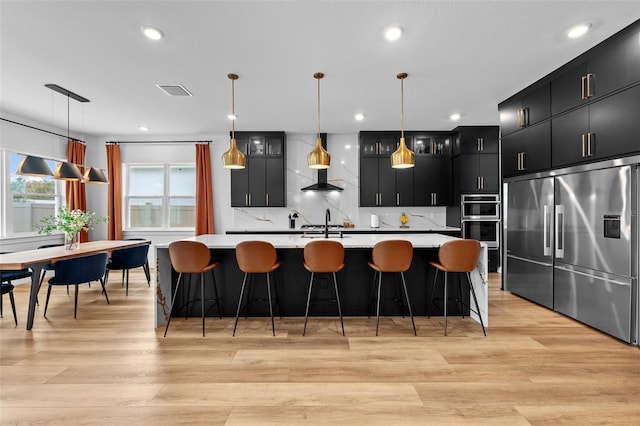 8720 Drummer Plank Dr, Wesley Chapel, FL 33545 - kitchen featuring dark cabinets, light countertops, ventilation hood, and stainless steel appliances