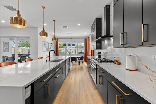 8720 Drummer Plank Dr, Wesley Chapel, FL 33545 - kitchen with a sink, light wood finished floors, wall chimney exhaust hood, a healthy amount of sunlight, and visible vents