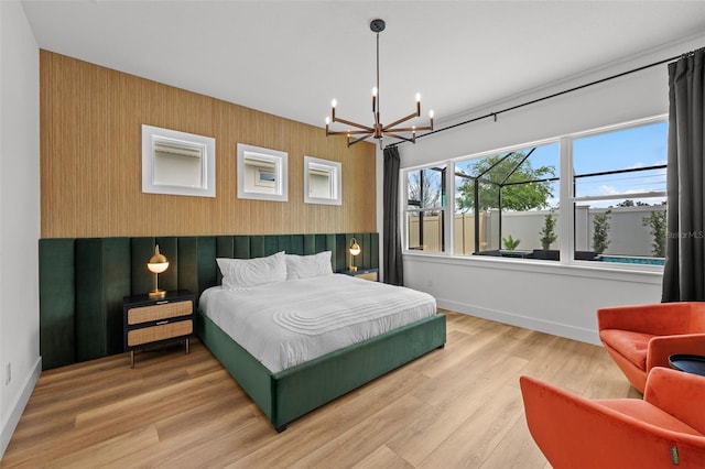 8720 Drummer Plank Dr, Wesley Chapel, FL 33545 - bedroom featuring baseboards, wood finished floors, and a notable chandelier