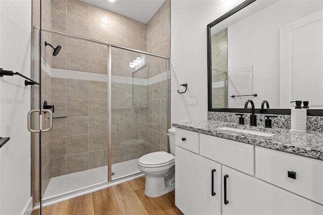 8720 Drummer Plank Dr, Wesley Chapel, FL 33545 - bathroom featuring vanity, a shower stall, toilet, and wood finished floors