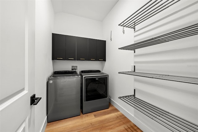 8720 Drummer Plank Dr, Wesley Chapel, FL 33545 - laundry room featuring separate washer and dryer, light wood-style flooring, cabinet space, and baseboards
