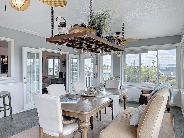 sunroom featuring french doors and healthy amount of natural light