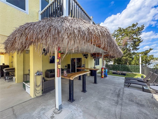 view of community with a patio, fence, and an outdoor hangout area