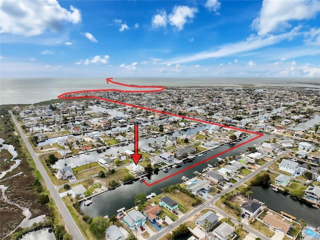 view of property location featuring a nearby body of water and nearby suburban area