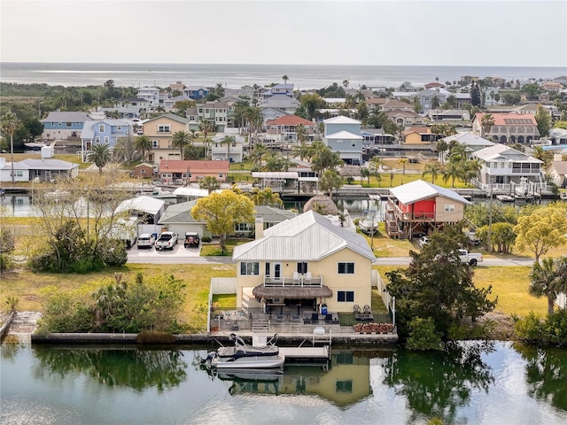 aerial view of residential area featuring a nearby body of water