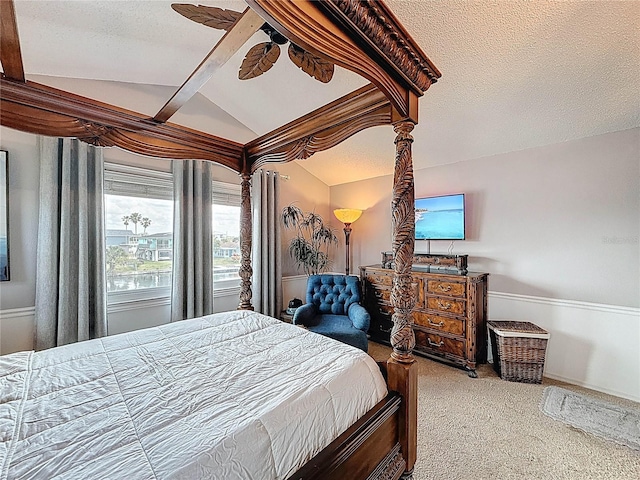 carpeted bedroom featuring lofted ceiling, a textured ceiling, and ceiling fan