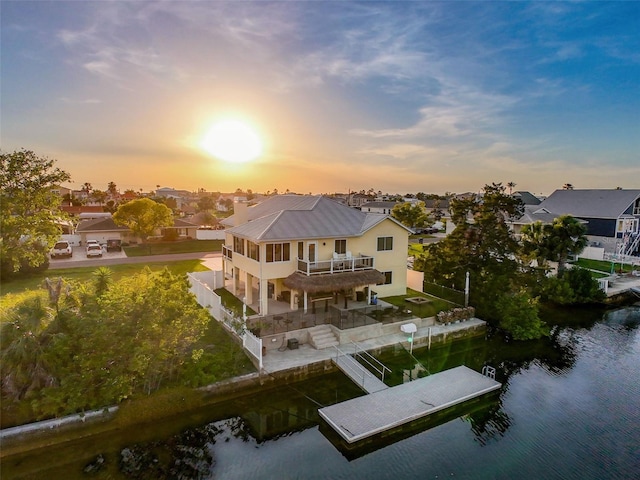 4116 Diaz Ct, Hernando Beach, FL 34607 - rear view of house featuring a water view, metal roof, stucco siding, a residential view, and stairs