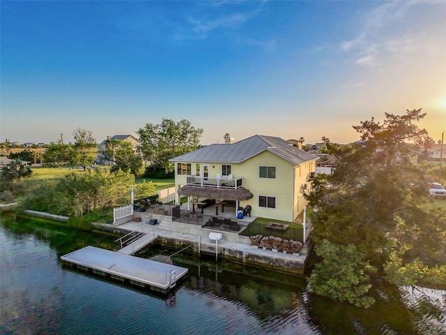 4116 Diaz Ct, Hernando Beach, FL 34607 - back of property featuring a water view, metal roof, a patio, a balcony, and stucco siding