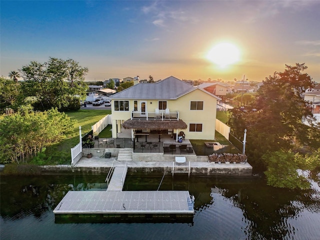 4116 Diaz Ct, Hernando Beach, FL 34607 - rear view of property featuring a water view, a patio, stairway, a balcony, and stucco siding