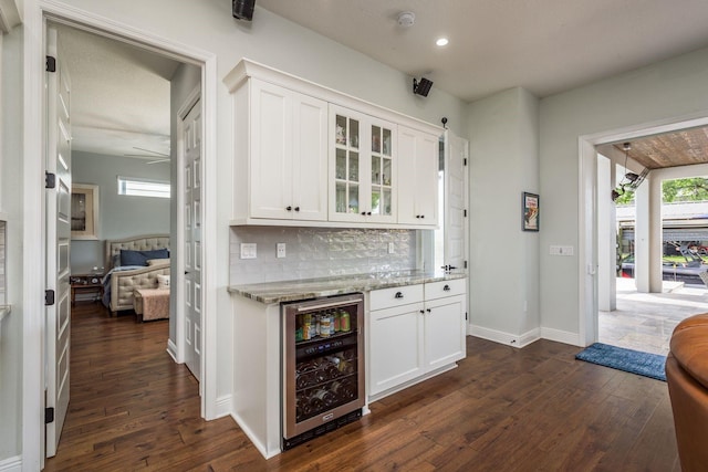 182 E Canal Dr, Palm Harbor, FL 34684 - bar with dark wood-type flooring, wine cooler, backsplash, and a wealth of natural light