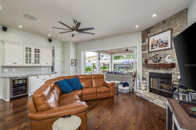 182 E Canal Dr, Palm Harbor, FL 34684 - living area with dark wood-style floors, ceiling fan, and beverage cooler