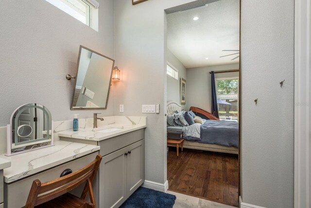 182 E Canal Dr, Palm Harbor, FL 34684 - ensuite bathroom with vanity, baseboards, a wealth of natural light, and connected bathroom