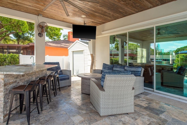 182 E Canal Dr, Palm Harbor, FL 34684 - view of patio featuring a storage shed, fence, an outdoor structure, and outdoor dry bar