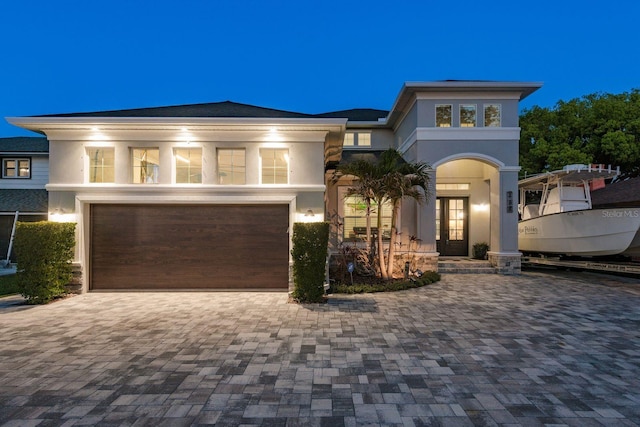182 E Canal Dr, Palm Harbor, FL 34684 - view of front facade with french doors, an attached garage, driveway, and stucco siding