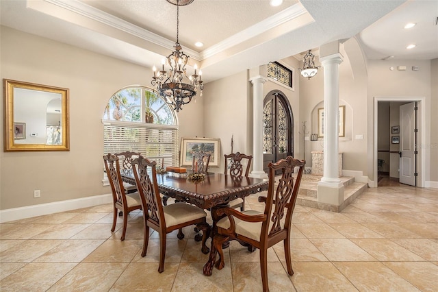 3607 Berger Rd, Lutz, FL 33548 - dining area with ornate columns, crown molding, a tray ceiling, a chandelier, and a textured ceiling