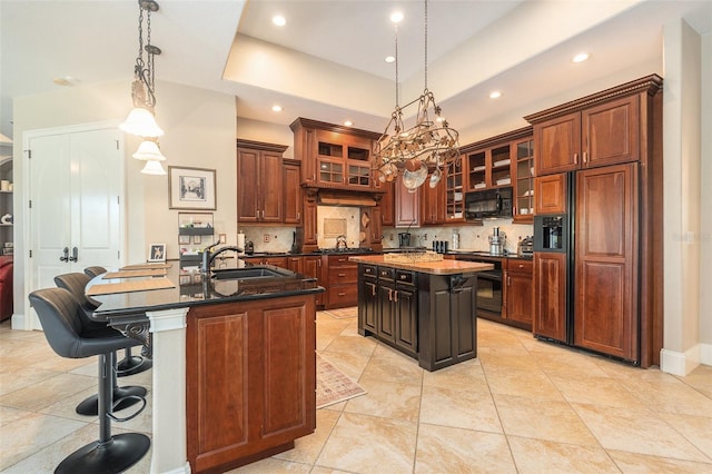 3607 Berger Rd, Lutz, FL 33548 - kitchen featuring paneled refrigerator, a center island with sink, black microwave, backsplash, and recessed lighting