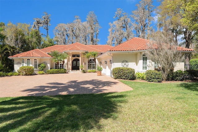 3607 Berger Rd, Lutz, FL 33548 - mediterranean / spanish-style home featuring a tiled roof, stucco siding, a garage, a front yard, and driveway