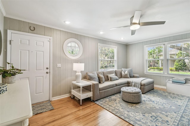 living room featuring recessed lighting, light wood-type flooring, ornamental molding, baseboards, and a ceiling fan