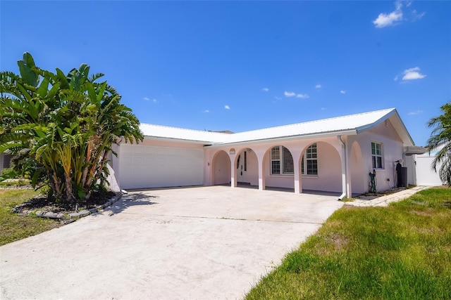 single story home with concrete driveway, stucco siding, a porch, and a garage