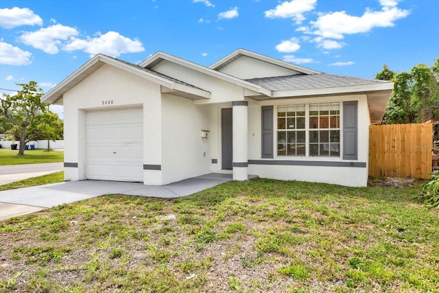 ranch-style house featuring concrete driveway, stucco siding, fence, an attached garage, and a front lawn