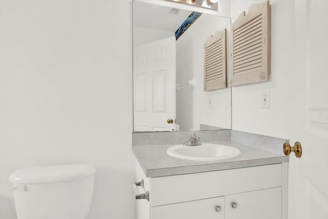 bathroom with toilet and vanity