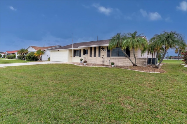 733 Ojai Ave, Sun City Center, FL 33573 - ranch-style home with brick siding, driveway, an attached garage, and a front lawn
