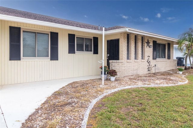 733 Ojai Ave, Sun City Center, FL 33573 - view of front of home featuring brick siding and a shingled roof