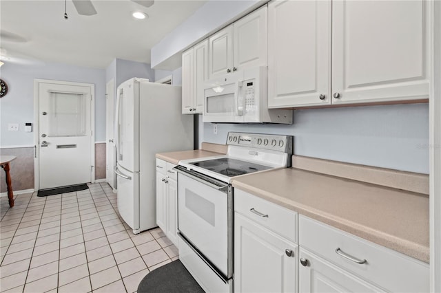 733 Ojai Ave, Sun City Center, FL 33573 - kitchen with white electric range oven, white cabinets, light tile patterned floors, ceiling fan, and light countertops